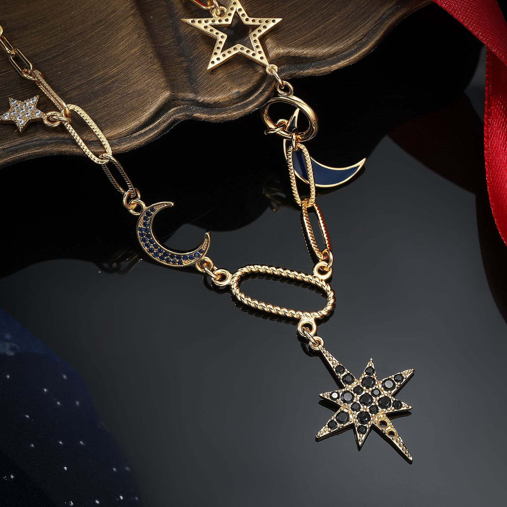 Gold necklace with star and moon pendants on a dark surface
