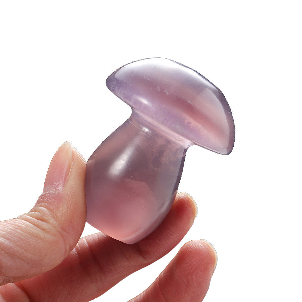 Purple silicone cupping device held in a hand against a white background