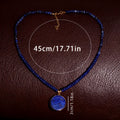 Blue beaded necklace with a pendant on a brown textured background