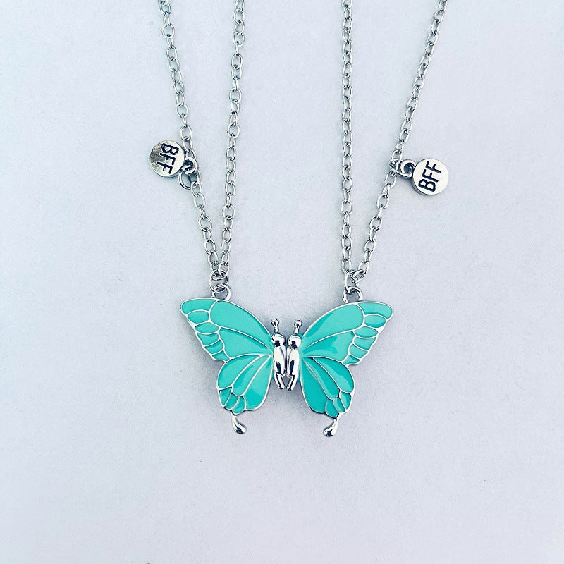 Turquoise butterfly pendant necklace on a light gray background
