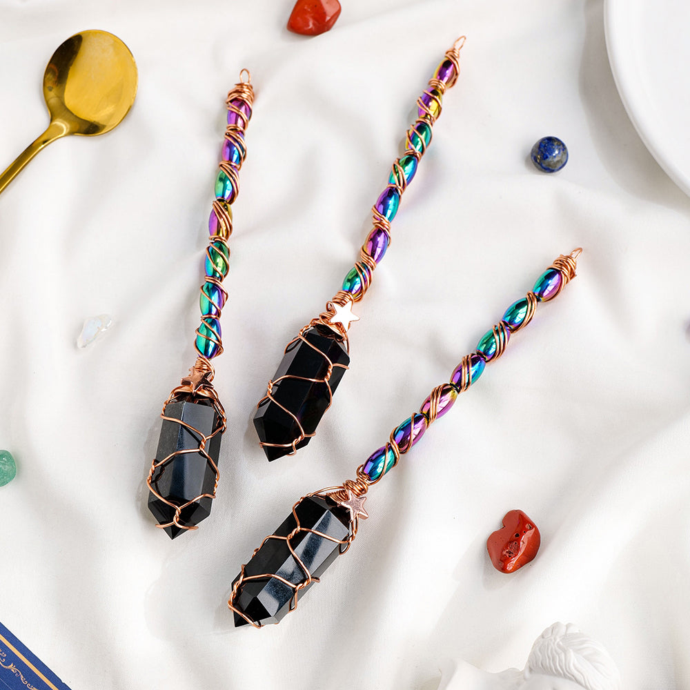 Colorful beaded earrings with black stone accents on a white surface.