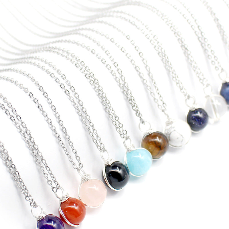 Necklaces with colorful beads on silver chains against a white background