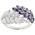 Ring with purple and clear gemstones on a white background