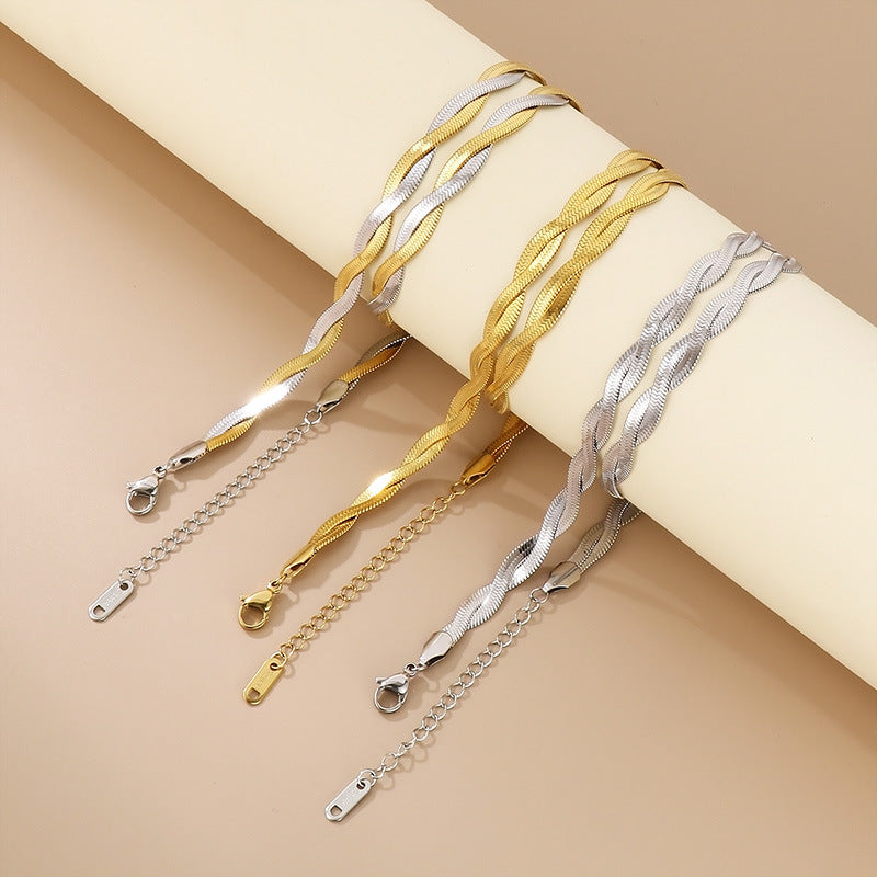 Gold and silver bracelets on a beige background