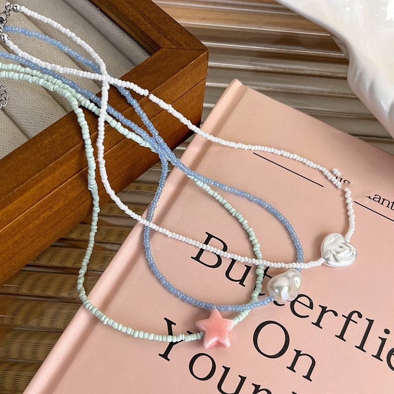 Set of beaded necklaces on a book with a wooden surface