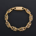 Gold bracelet with floral designs and blue stones on a black background
