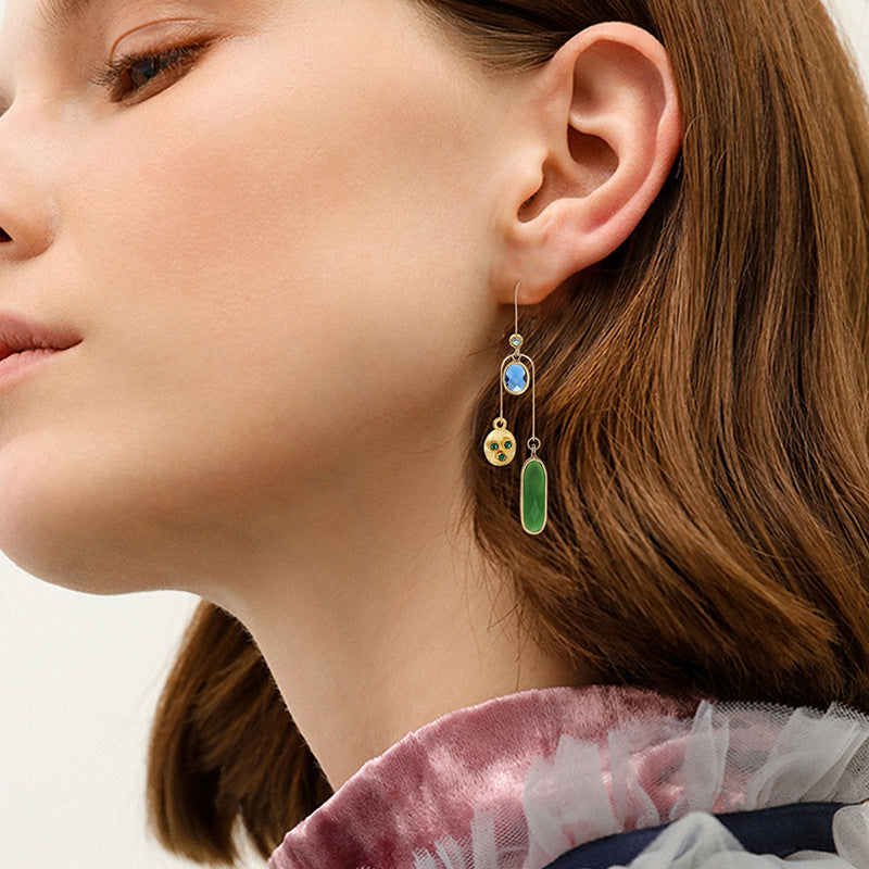 Close-up of a woman wearing a colorful earring with a blurred background