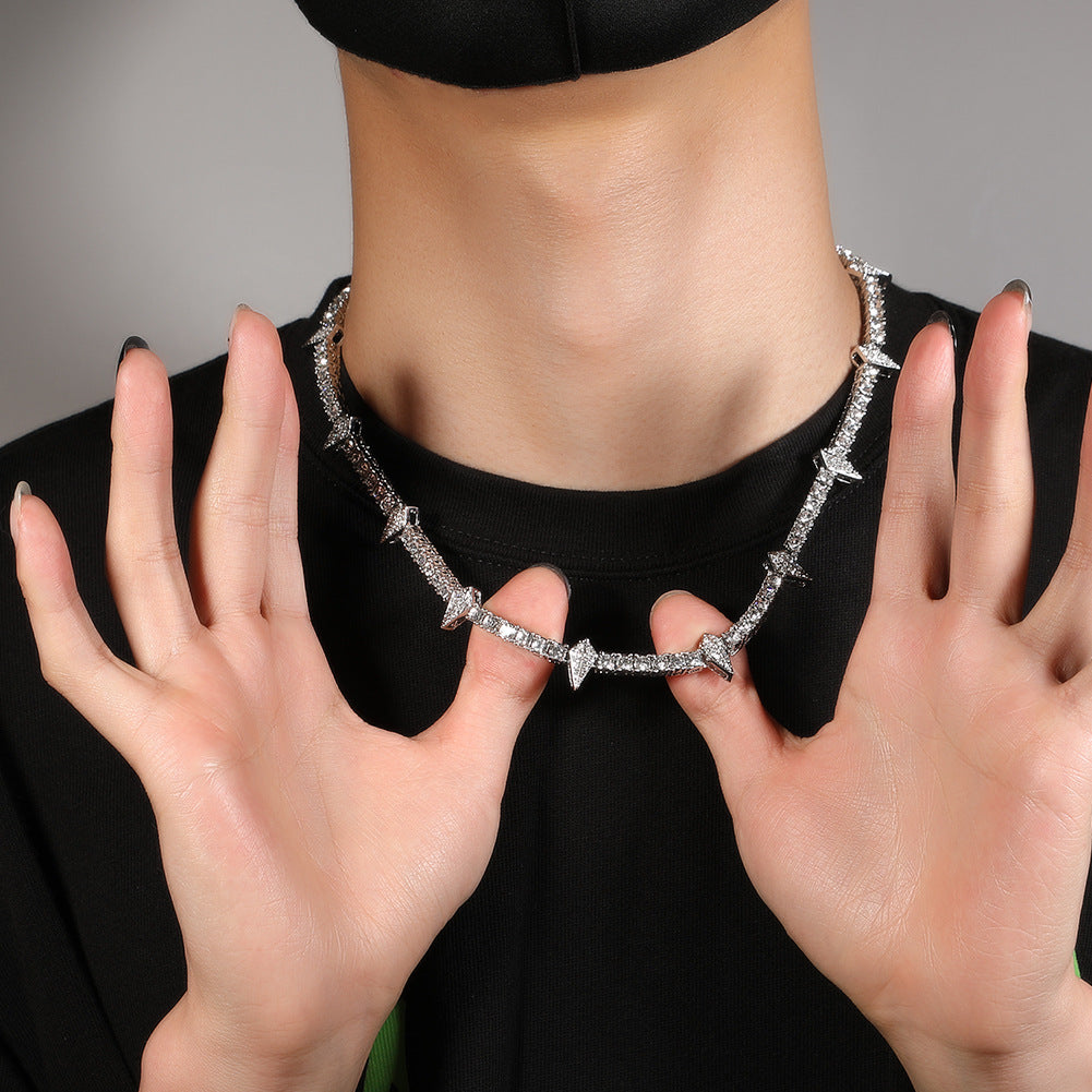 Person wearing a silver necklace with hands holding it out