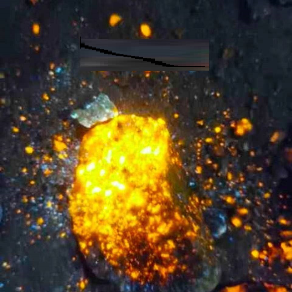 Close-up of a glowing orange and blue object against a dark background