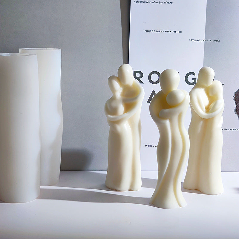 Three white ceramic figures on a light gray surface with a blurred background