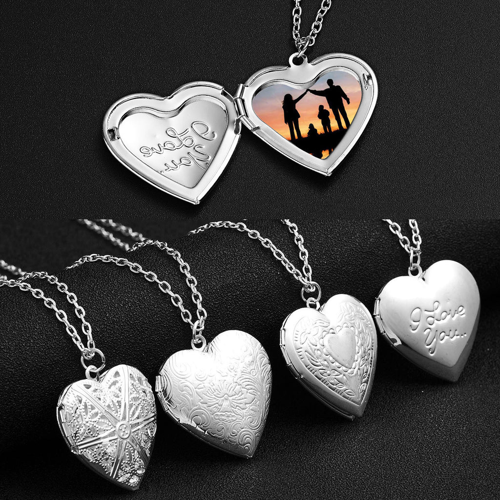 Heart-shaped silver locket with engraved text and a silhouette of a family at sunset on a black background.