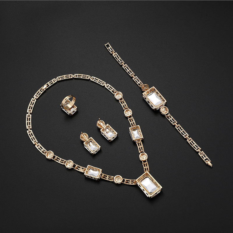 Gold necklace with square gemstones on a black background