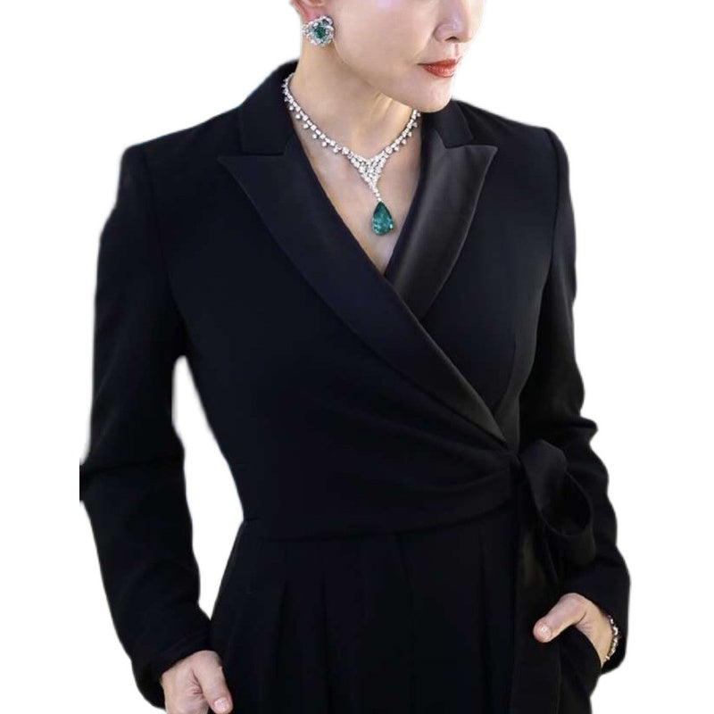 Black blazer worn by a person on a white background