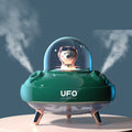 UFO-shaped air humidifier with a cartoon character inside, emitting steam on a blue background.