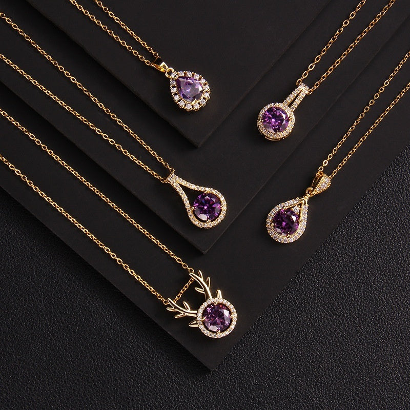 Gold necklaces with purple gemstones on a black background