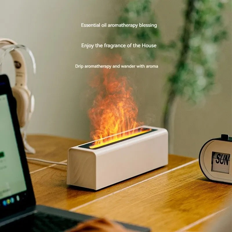 Small indoor fireplace on a desk with laptop and clock in the background
