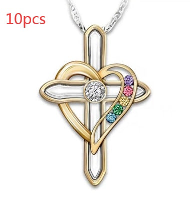 Gold cross pendant with heart design and colorful stones on a white background