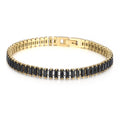 Gold bracelet with black stones on a white background