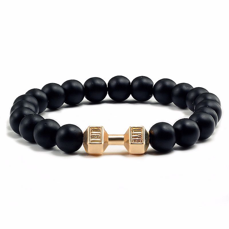 Black beaded bracelet with a gold dumbbell-shaped clasp on a white background