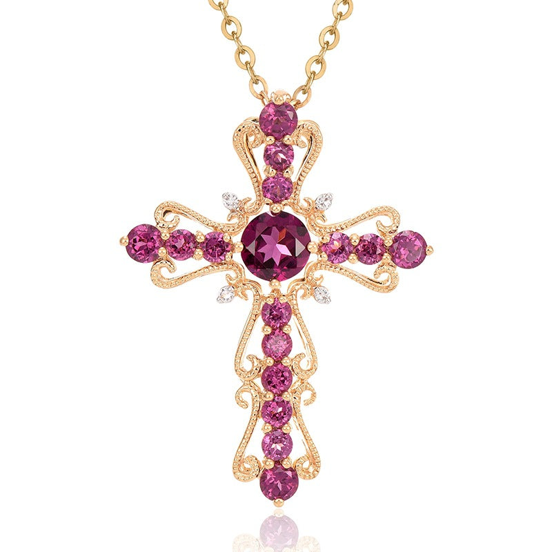 Gold cross necklace with pink gemstones on a white background