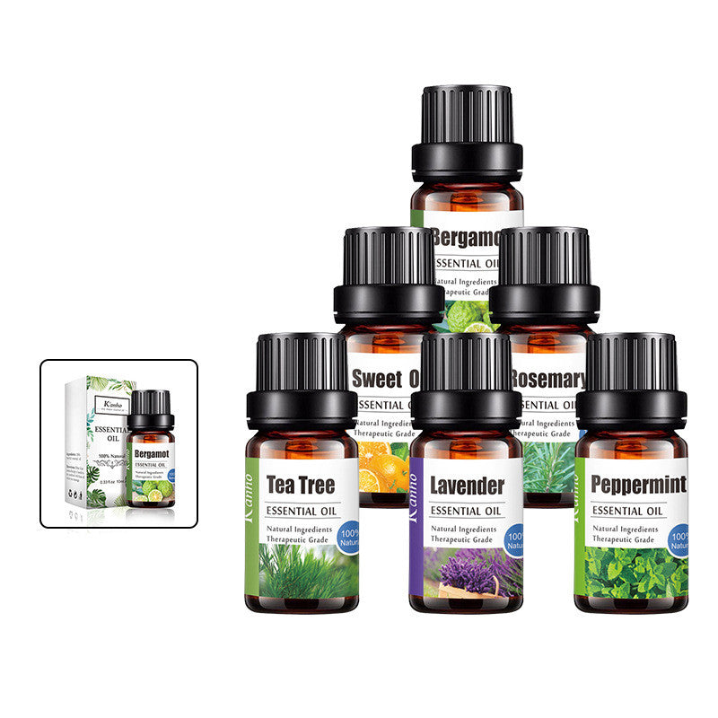 Collection of essential oil bottles with labels on a white background
