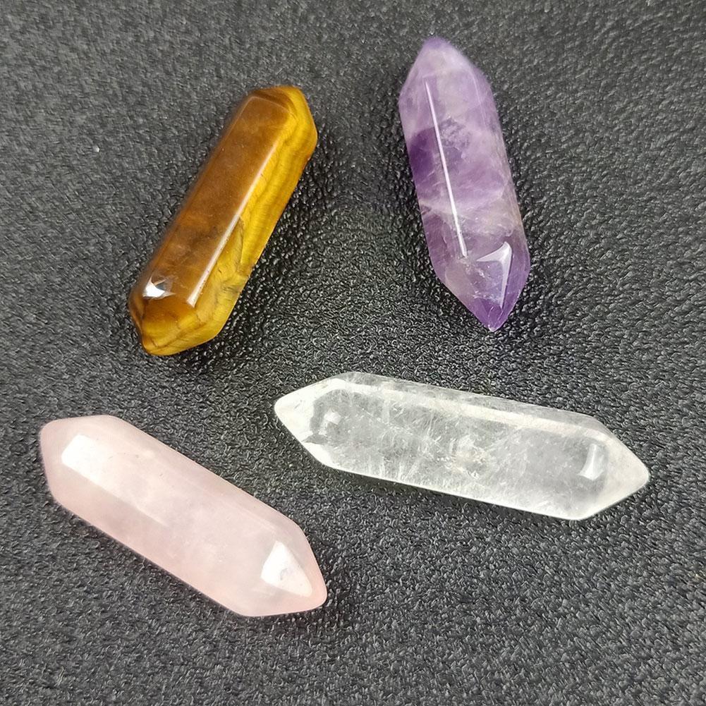 Four crystal stones on a dark surface
