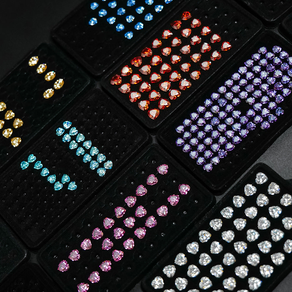 Collection of colorful rhinestone heart shapes on a black background