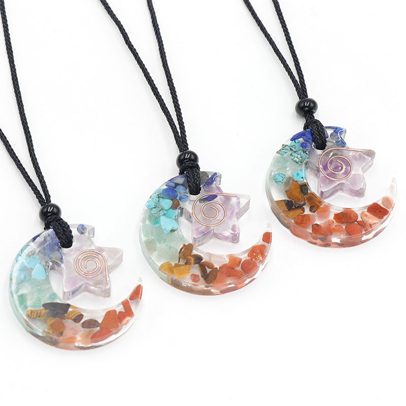 Three colorful star-shaped necklaces on black cords against a white background