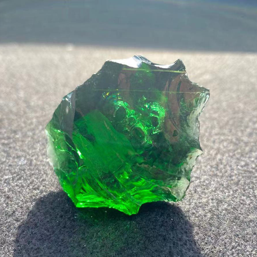 Green crystal on a textured surface