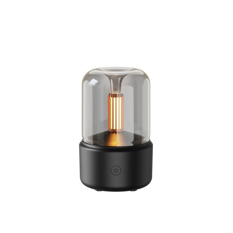 Small black lamp with a clear glass shade on a white background