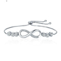 Silver bracelet with infinity design and clear stones on a white background