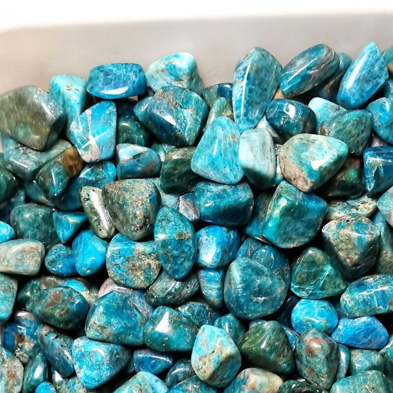 Turquoise stones in a white container