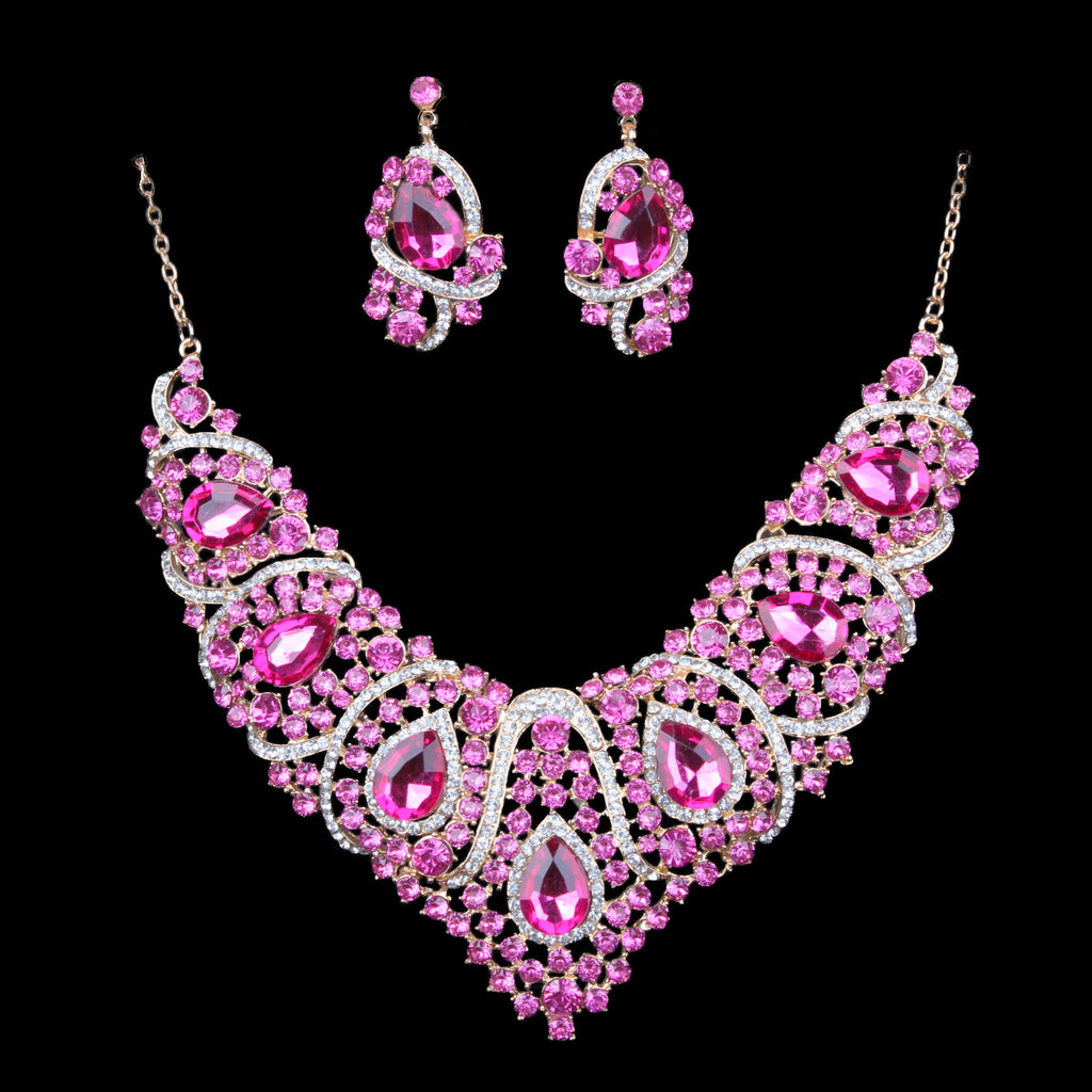 Pink jewelry set with necklace and earrings on a black background