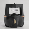 Black air fryer with a grating attachment on a light gray background