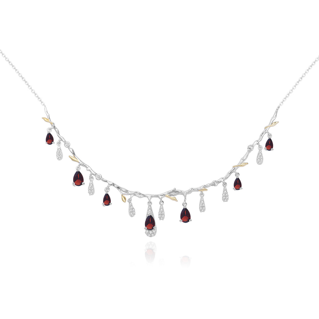 Necklace with red gemstones and clear stones on a white background