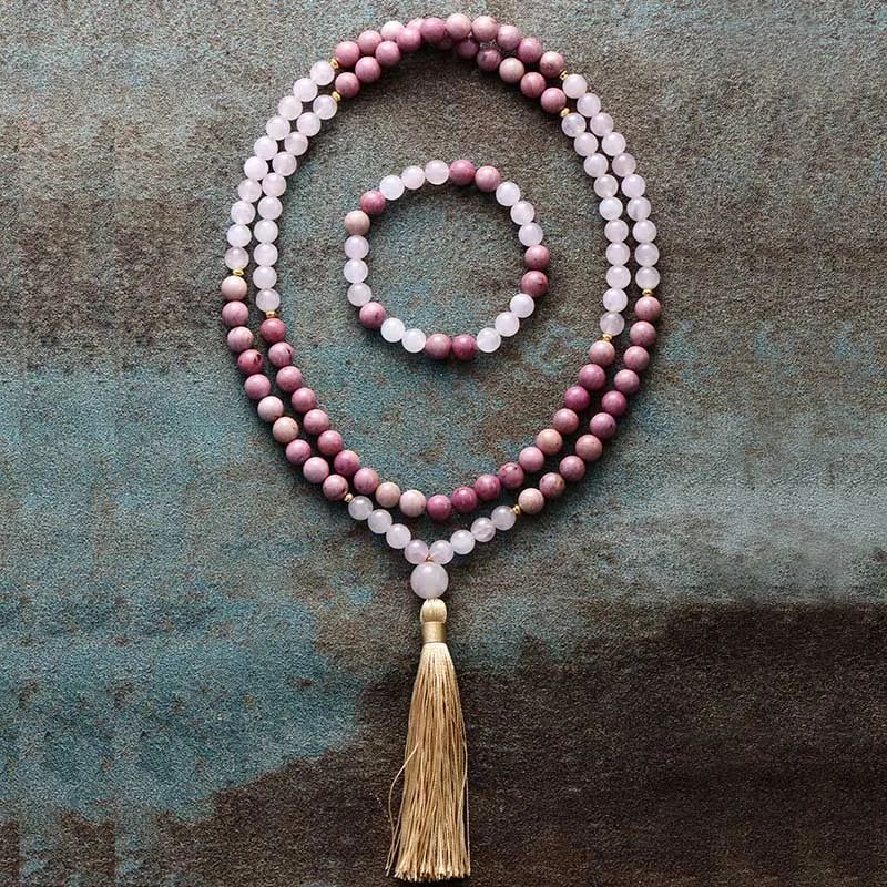 Beaded necklace with a tassel on a textured surface