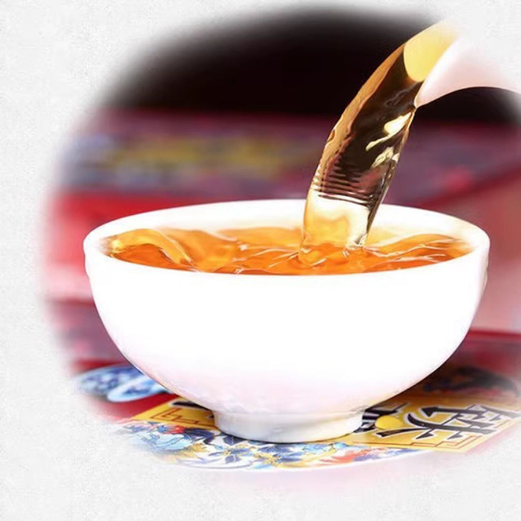 Tea being poured into a white ceramic teacup with a blurred background