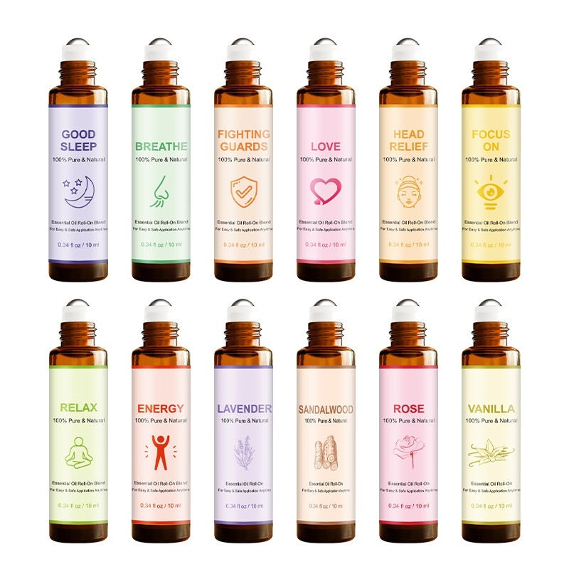 Row of 12 essential oil bottles with various labels on a white background