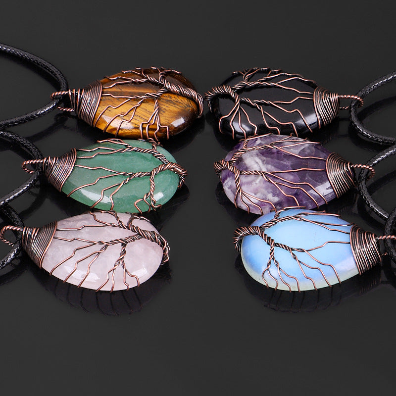 Set of colorful stone pendants with wire wrapping on a black background