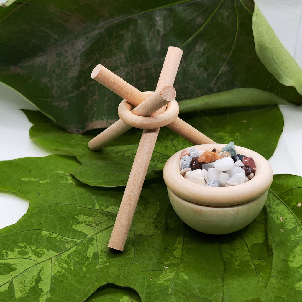 Wooden toy with sticks and stones on a leaf