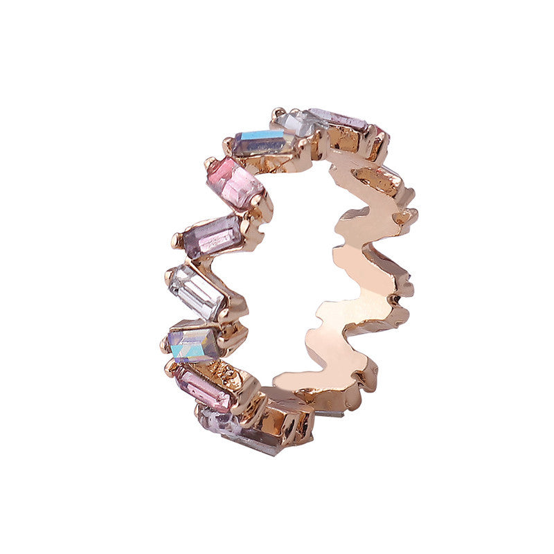 Ring with multicolored gemstones on a white background