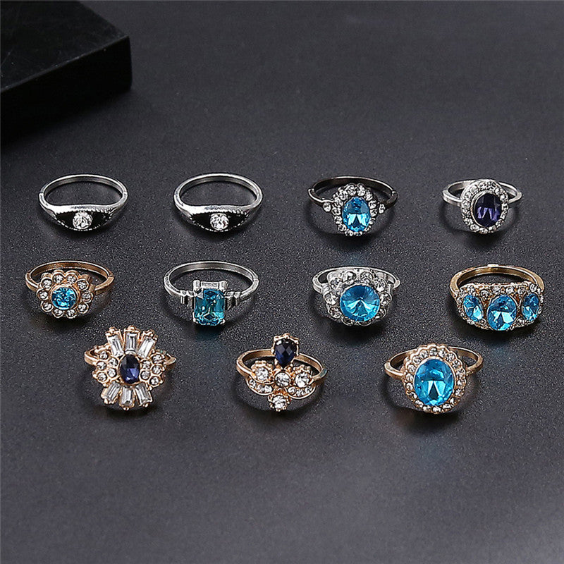 Collection of various rings with blue gemstones on a dark surface