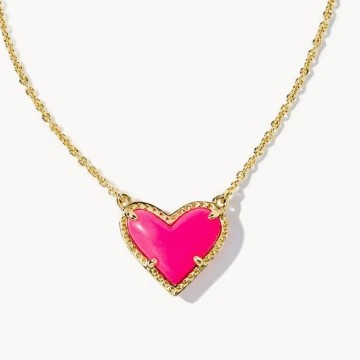 Neon pink heart-shaped pendant on a gold chain against a white background