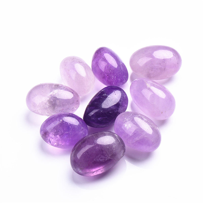 Purple and pink gemstones on a white background