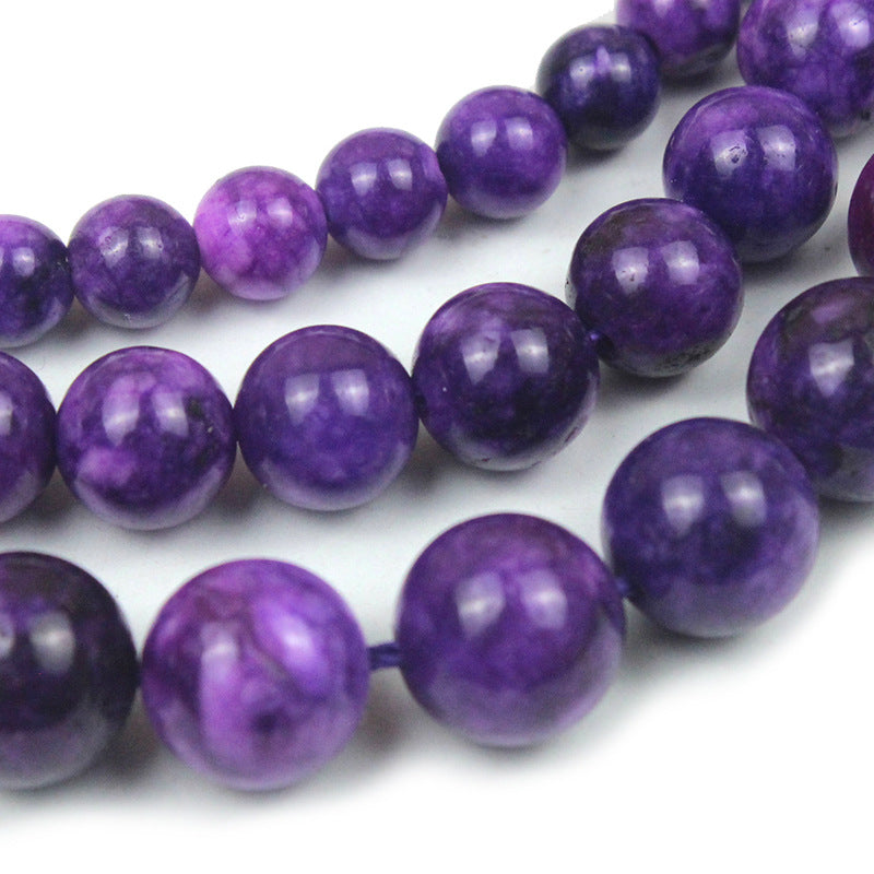 String of purple beads on a white background