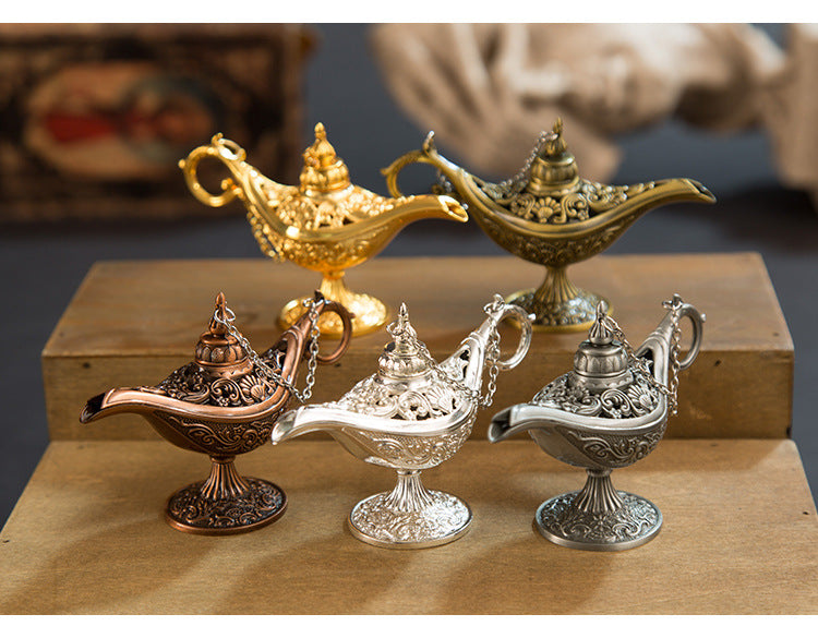 Collection of decorative Aladdin lamps in various colors on a wooden surface.