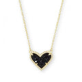Necklace with a black heart-shaped pendant on a gold chain against a white background