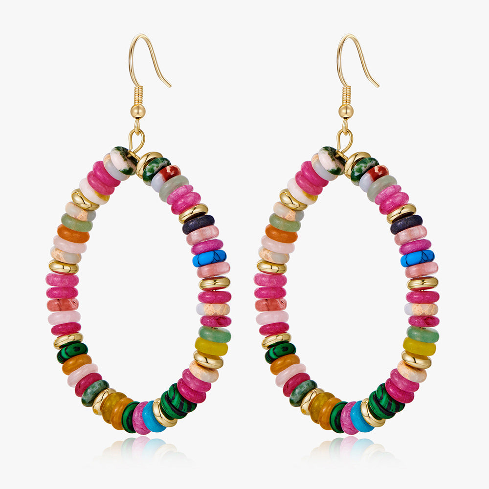 Colorful beaded hoop earrings on a white background