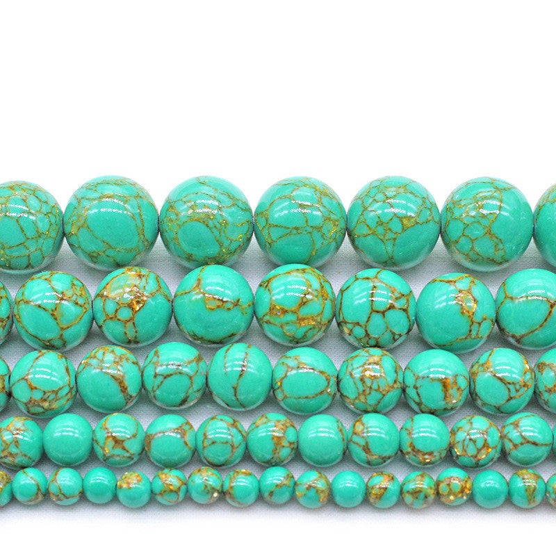 Turquoise beads with gold speckles on a white background