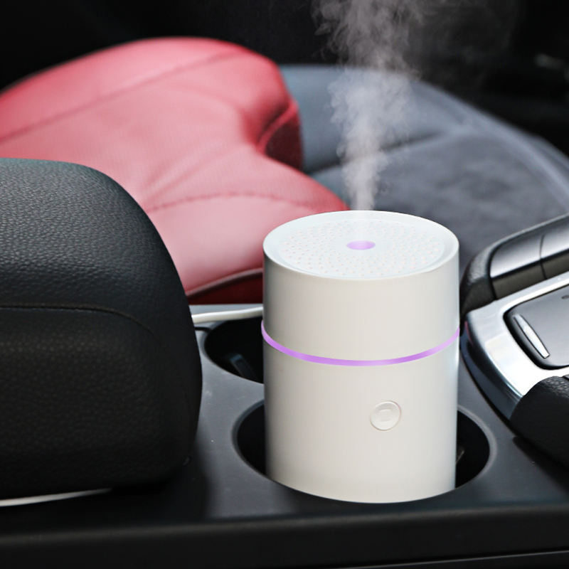 Car cup holder with a white humidifier emitting steam